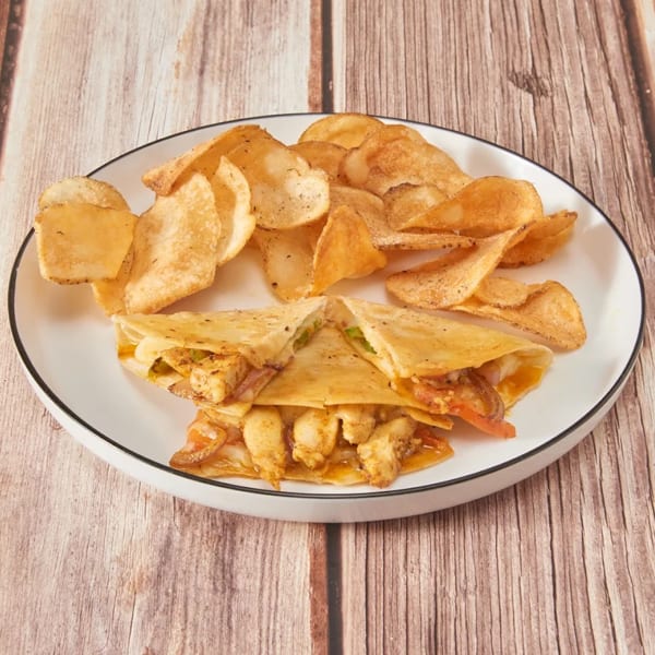 Chicken quesadillas with melted cheese and vegetables, served with a side of potato chips.